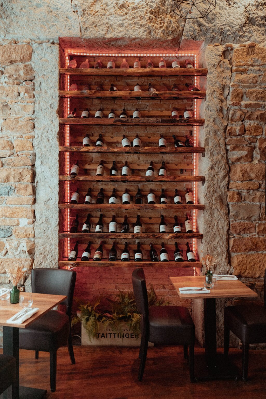 Wine cellar on a stone wall at ART restaurant, Lyon